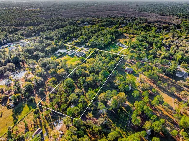 View of property location featuring property parcel outlined and a heavily wooded area