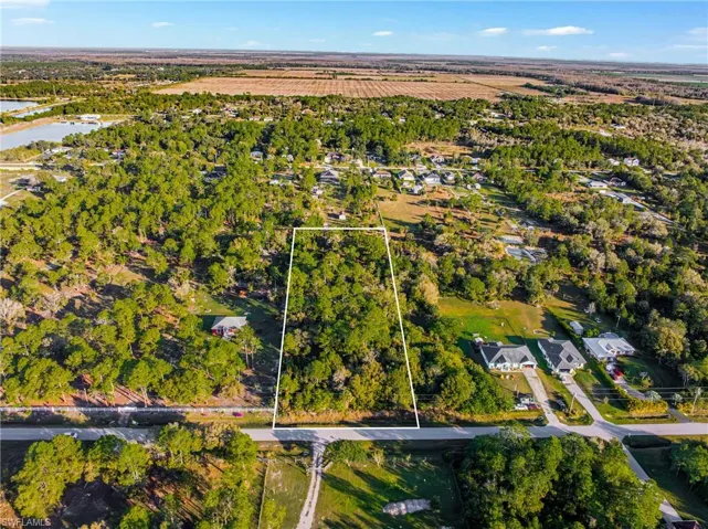 Aerial view of property and surrounding area featuring property boundaries highlighted