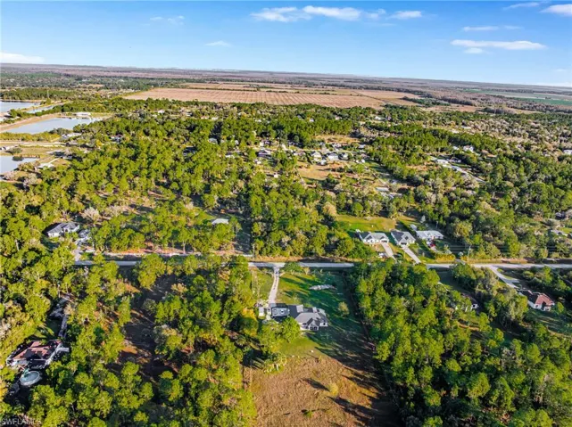 Aerial view of property and surrounding area featuring a nearby body of water