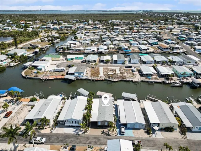 Aerial overview of property's location with a nearby body of water and nearby suburban area