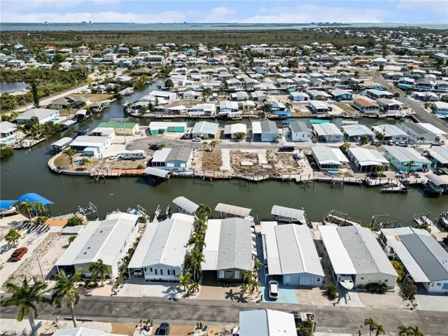 Aerial overview of property's location featuring a nearby body of water and nearby suburban area