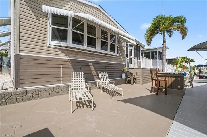 View of patio featuring a Poly deck and a sunroom