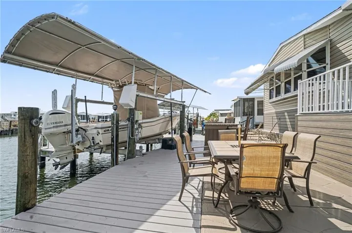 Dock area featuring boat lift and a water view