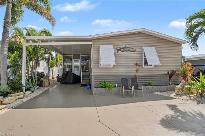 Front of property with a carport, a patio area, and concrete driveway