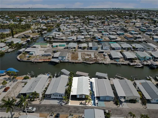 Aerial view of property's location featuring a large body of water and nearby suburban area