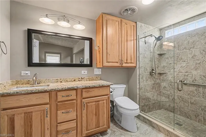 Bathroom with vanity and a shower stall