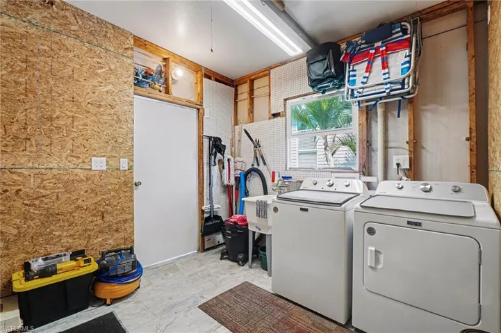 Laundry area featuring a shop with separate washer and dryer