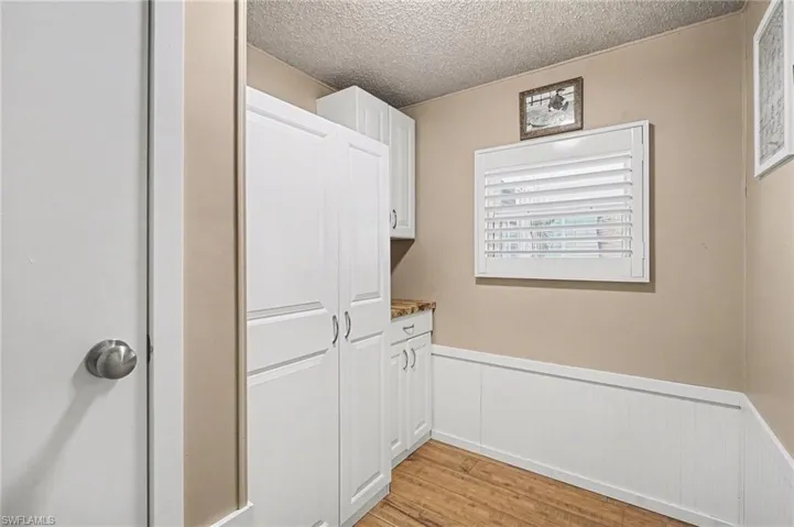 Storage room with light wood-style floors.