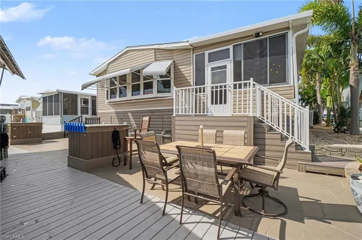 Poly decking with a patio area, a sunroom, and outdoor dining space