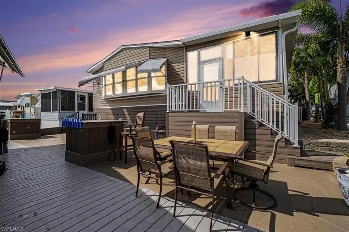 Deck with a sunroom, a patio, outdoor dining space, and large sun deck