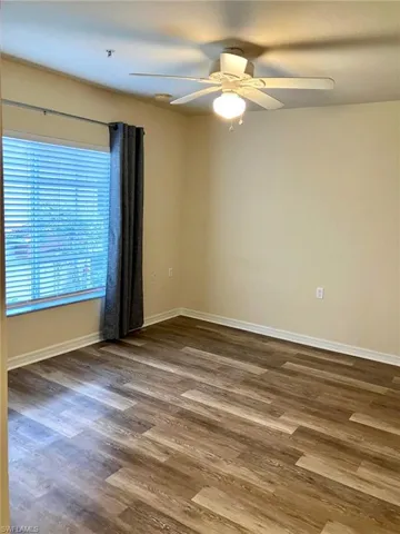 The primary bedroom is large and light filled.  A fan keeps things cool and a walk in closet keeps things organized.