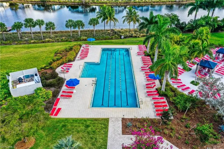 View of pool featuring a water view and a lawn