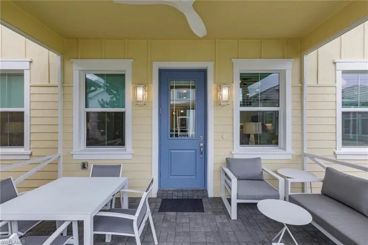 Doorway to property with ceiling fan