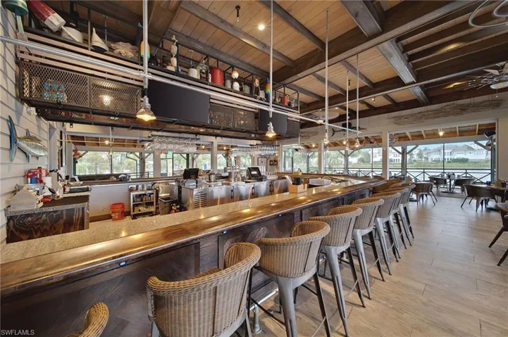 Bar featuring beamed ceiling, decorative light fixtures, and wood ceiling