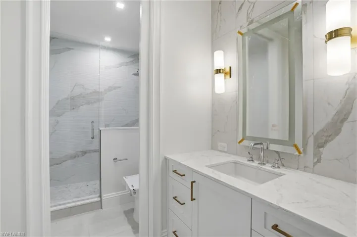 Bathroom with vanity and a stall shower