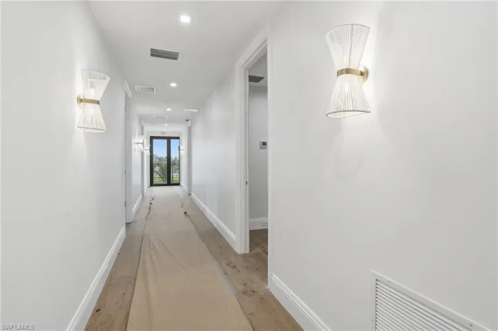 Hallway featuring light wood-style floors and recessed lighting