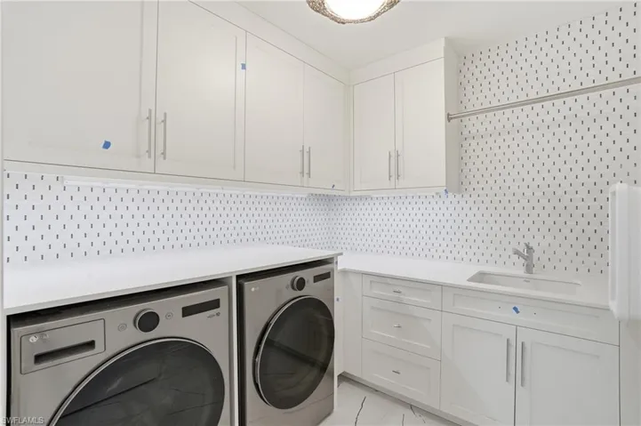Laundry room featuring cabinet space and washer and dryer