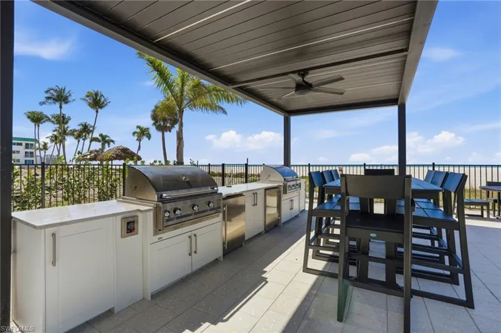 View of patio / terrace with an outdoor kitchen / dining area and a ceiling fan