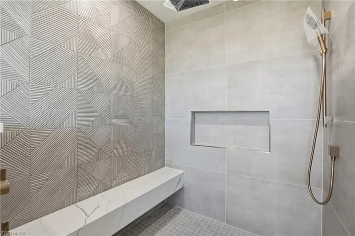 Bathroom featuring tiled shower and pet washing area