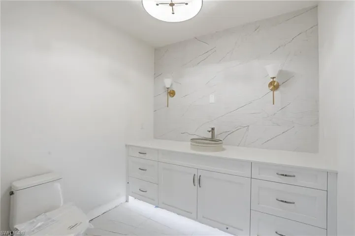 Bathroom featuring vanity and toilet