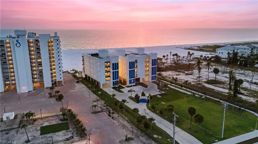 Drone / aerial view of a large body of water and apartment complex