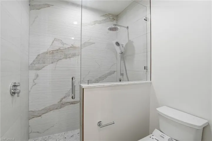 Bathroom featuring a stall shower and toilet