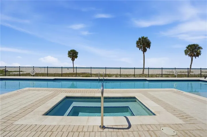 Community pool with a hot tub and a patio