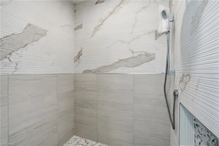 Bathroom featuring a tile shower