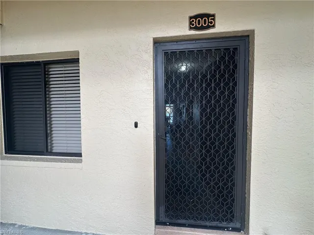 Entrance to property featuring stucco siding