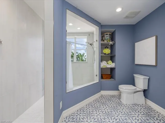 Bathroom with walk in shower and recessed lighting