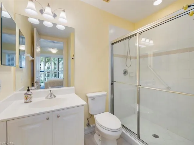 Full bath with connected bathroom, a shower stall, and vanity