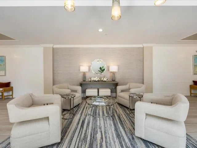 Living room featuring wood finished floors, crown molding, and recessed lighting
