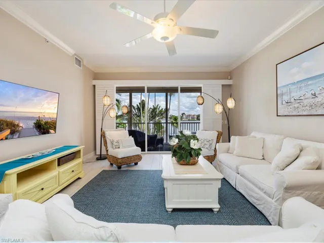 Living room with ornamental molding, wood finished floors, and ceiling fan