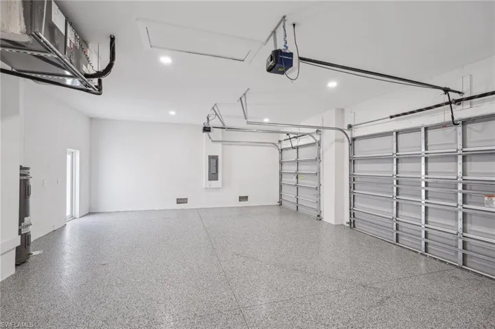 Garage with a garage door opener and electric panel