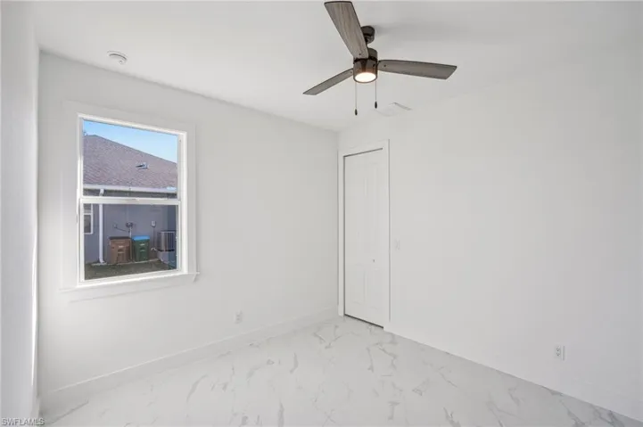 Spare room with ceiling fan