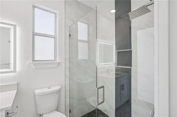 Bathroom with vanity, toilet, and walk in shower