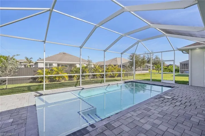 View of pool with a lanai, a yard, and a patio