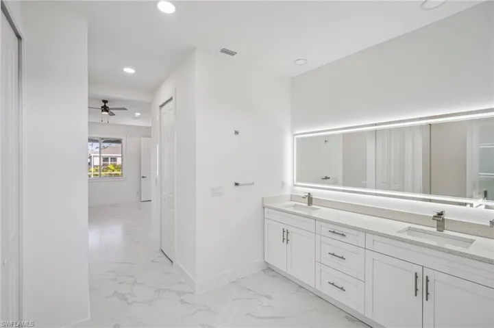 Bathroom with ceiling fan and vanity