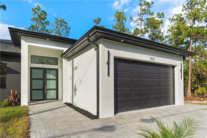Garage featuring driveway and french doors
