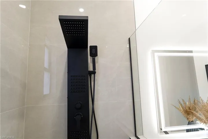 Bathroom view of a tile shower