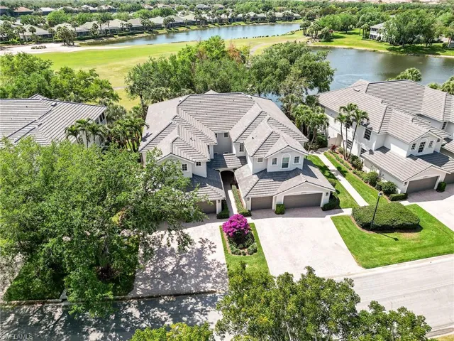 Aerial perspective of suburban area with a large body of water and a golf course