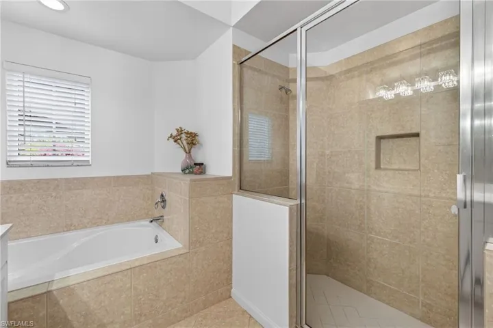 Full bath with a shower stall, a bath, and vanity