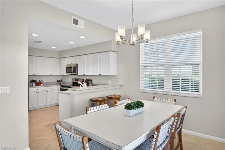 Dining area featuring hanging lights and light tile patterned flooring