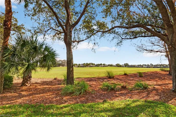 View of green lawn with golf course view