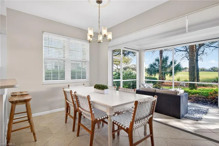 Dining area with suspended lighting and light tile patterned floors