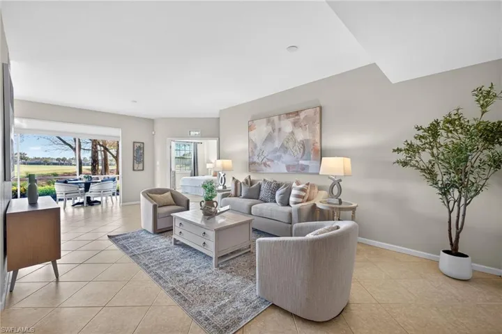 Living area featuring light tile patterned floors and baseboards