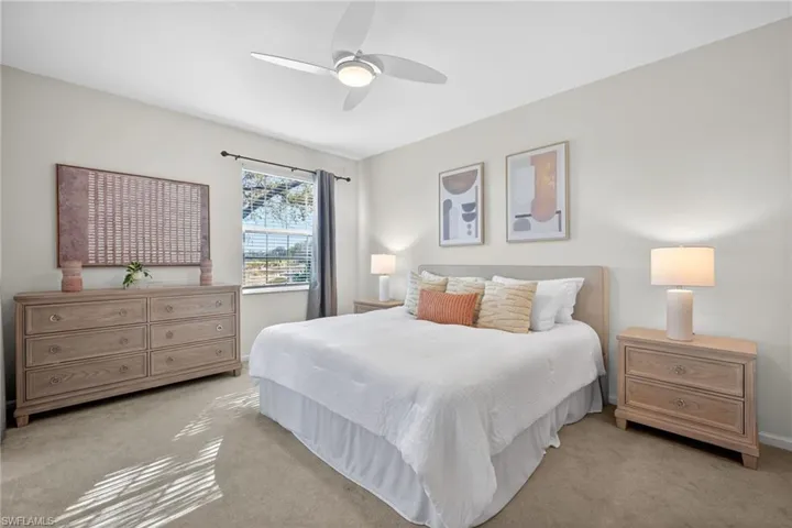 Carpeted bedroom with ceiling fan