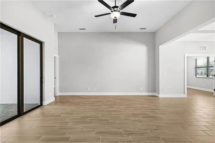 Spare room featuring wood tiled floors and a ceiling fan