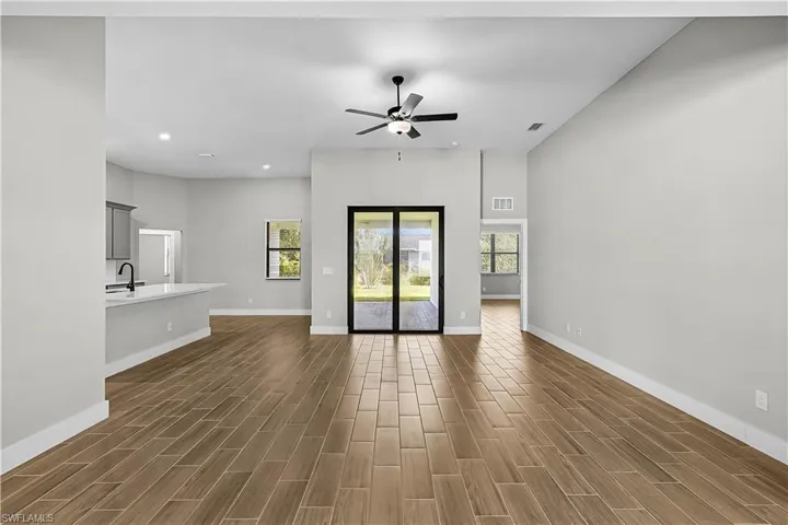 Unfurnished living room featuring recessed lighting, wood tiled floors, and a ceiling fan