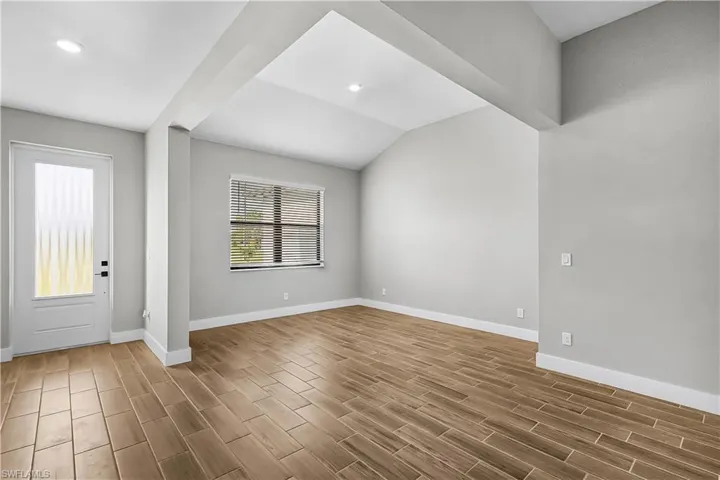 Foyer entrance with wood tiled floors and recessed lighting